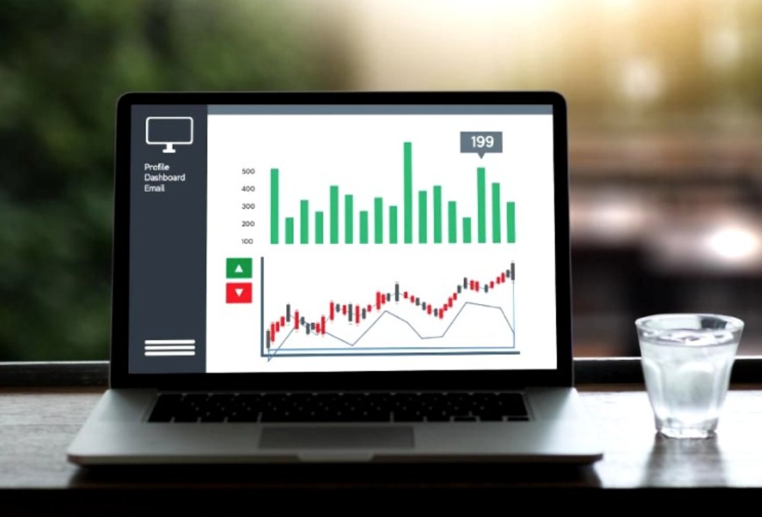 Laptop displaying a business dashboard with bar and line charts